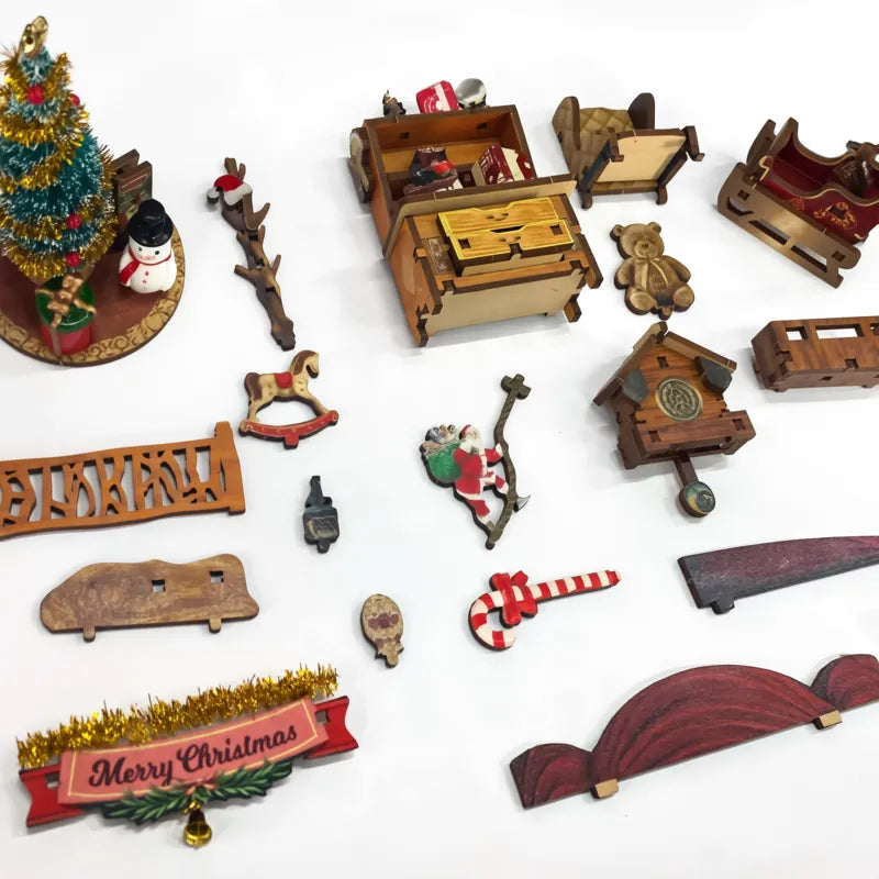 Componenti pretagliati e piccoli arredi della Christmas Jingle Cabin prima del montaggio