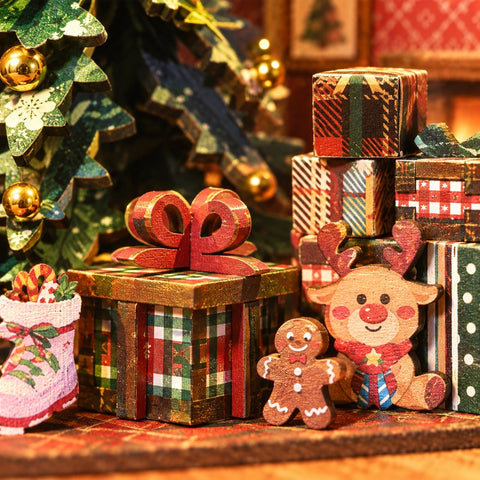 Geschenke und kleine Rentierfigur unter dem Weihnachtsbaum