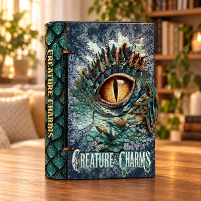 Creature Charms mit gestaltetem Buchrücken und Drachenauge-Cover