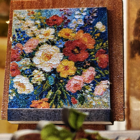 Farbenreiches Blumenbild auf einer hölzernen Staffelei