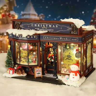 Negozio di Natale in miniatura visto di tre quarti tra neve e luci
