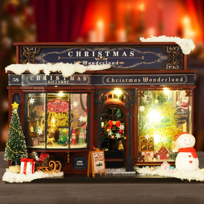 Facciata illuminata del negozio Christmas Wonderland con neve e pupazzo
