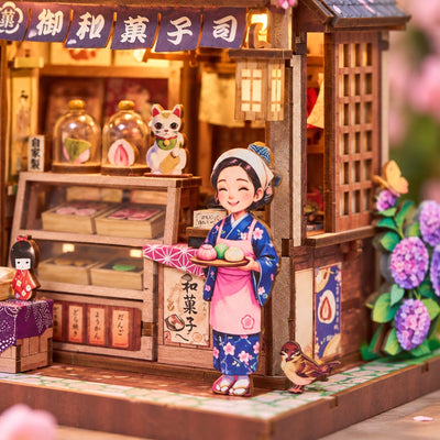 Kimono-clad shopkeeper in front of the sweet display